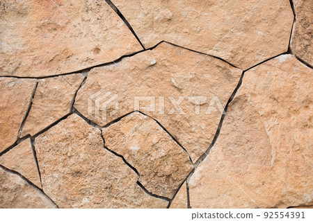 Masonry walls of natural sand color. Stone texture close-up, construction and mining background. 92554391