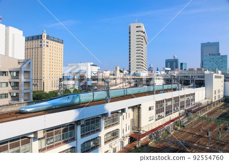 High-speed driving test train for Shinkansen running against the background of the building E956 type train ALFA-X High-speed driving test train for Shinkansen running against the background of the building E956 type train ALFA-X 92554760