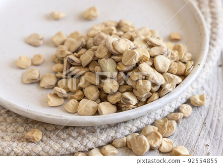 Plate of raw dry Grass pea close up on wooden table. Legumes known in Italy as Cicerchia 92554855