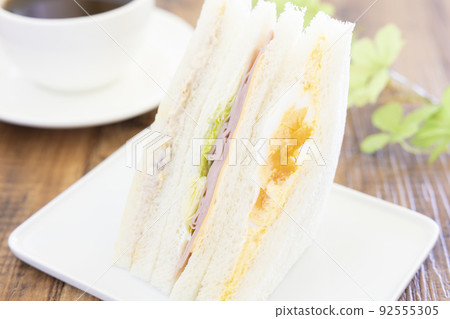 Delicious mixed sandwiches and coffee Delicious mixed sandwiches and coffee 92555305