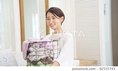 Middle woman with a laundry basket 92555743