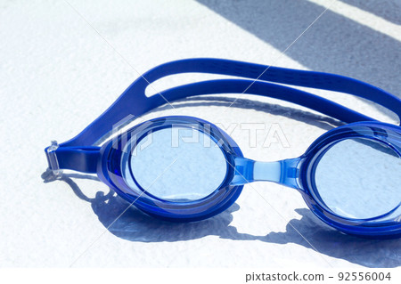 Blue goggles up on white background 92556004