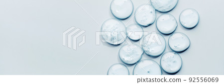 Liquid gel abstract cosmetic swatch drops on blue banner. Smear of transparent moisturizing product 92556069