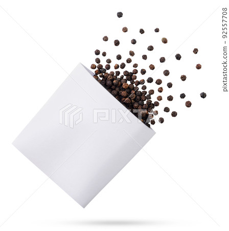 Peppercorns flies out of a pack close-up on a white background. Mockup 92557708