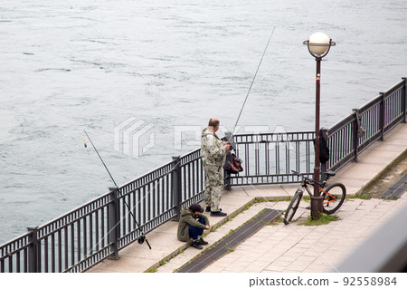 Irkutsk, Russia - July 31, 2021, Father and son are fishing in the Angara river. Editorial Irkutsk, Russia - July 31, 2021, Father and son are fishing in the Angara river. Editorial 92558984