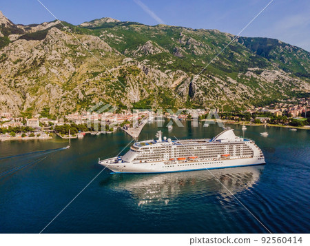 Luxury passenger liner in the bay of Kotor with travel returning after the Covid 19 pandemic Portrait of a disgruntled girl sitting at a cafe table Luxury passenger liner in the bay of Kotor with travel returning after the Covid 19 pandemic Portrait of a disgruntled girl sitting at a cafe table 92560414