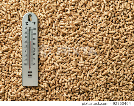 Air thermometer over wood pellets background. 92560464