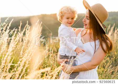 Cute mother with her son in nature. Cute mother with her son in nature. 92560615