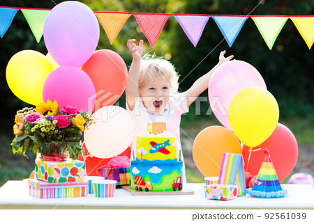 Kids birthday party. Child blowing out cake candle Kids birthday party. Child blowing out cake candle 92561039