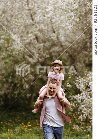 Father and little daughter are walking. Father and little daughter are walking. 92561123