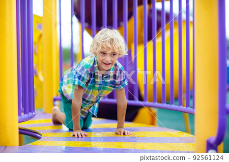 Child on playground. Kids play outdoor. Child on playground. Kids play outdoor. 92561124