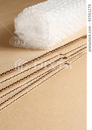 Cardboard, open boxes and bubble wrap. The concept of careful packaging of parcels. Copy space. Cardboard, open boxes and bubble wrap. The concept of careful packaging of parcels. Copy space. 92561278