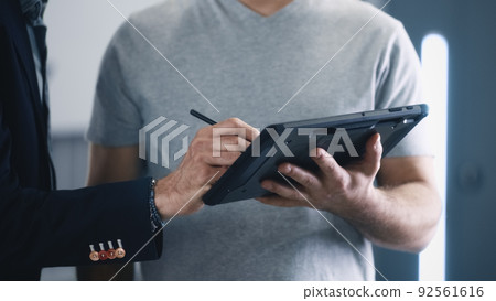 Male client accepting car diagnostics Male client accepting car diagnostics 92561616