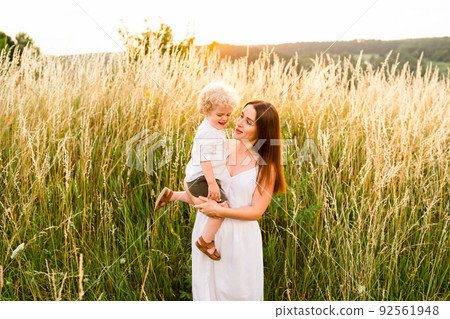 Mother with her son in her arms in nature 92561948