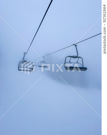 Ski Lift snowy mountain winter forest with chair lift At The Ski Resort in winter. Snowy weather Ski holidays Winter sport and outdoor activities Outdoor tourism Ski Lift snowy mountain winter forest with chair lift At The Ski Resort in winter. Snowy weather Ski holidays Winter sport and outdoor activities Outdoor tourism 92562664