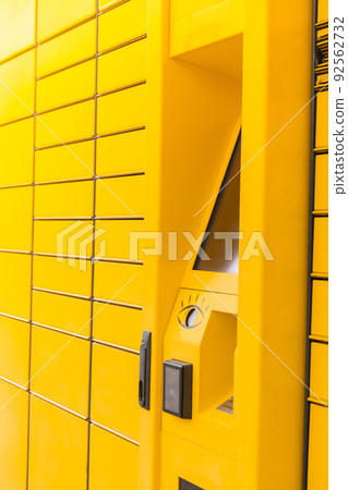 Modern yellow shopping locker. Bar code reader for Skans QR Code on Mobile phone Self-service Locker Cell Modern Shipping and Delivery Concept with Contactless Automated Postal Box. Parcel Locker 92562732