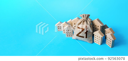 Polish zloty money bag surrounded by houses. Mortgage loan. Budget and funding. Construction industry. Housing appraisal. Valuation estimation. Real estate investment. Buying apartments. 92563078