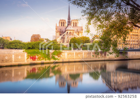 Notre Dame of Paris on Seine River reflection at sunrise, France 92563258