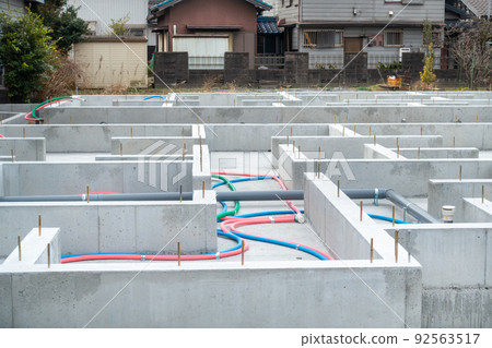 A photo of the foundation of a house. A photo of a house for sale under construction. 92563517