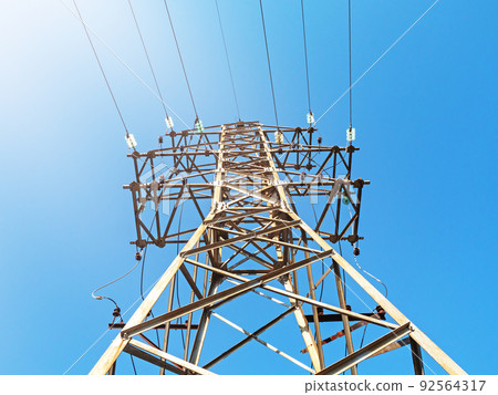 Electric pole with wires against the sky. Bottom view Electric pole with wires against the sky. Bottom view 92564317