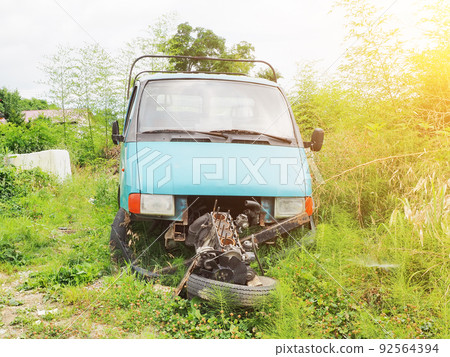 Truck engine broken. Abandoned obsolete car in the countryside. Car dismantled for parts. Engine replacement. Truck engine broken. Abandoned obsolete car in the countryside. Car dismantled for parts. Engine replacement. 92564394