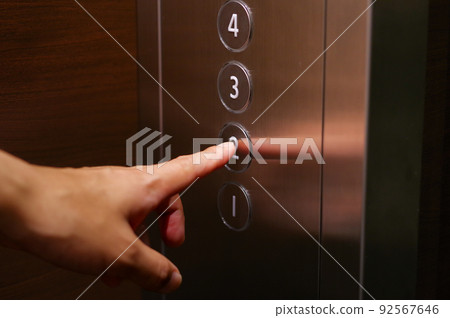 Hands of the person pushing the elevator button Hands of the person pushing the elevator button 92567646