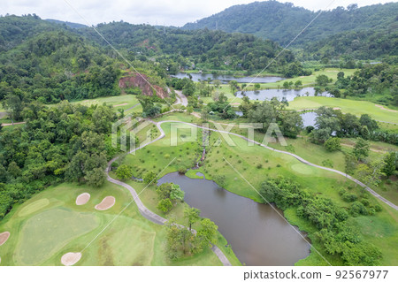 Aerial view drone shot of beautiful green golf field fairway and putting green Top down Aerial view drone shot of beautiful green golf field fairway and putting green Top down 92567977