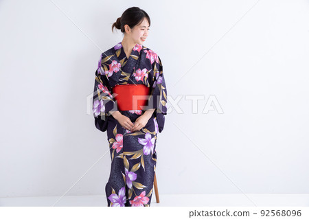 A woman wearing a yukata and sitting on a chair Japan A woman wearing a yukata and sitting on a chair Japan 92568096