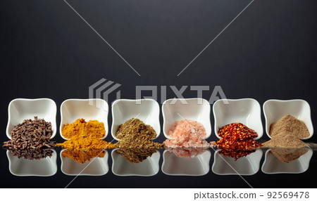 Small white bowls with various spices. Small white bowls with various spices. 92569478