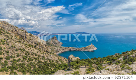 Beautiful seascape, panorama of cape Kapchik to the Galitsin Trail and blue bay of the Black Sea. Sudak, New World. Landscape of the sea coast. The concept of calmness, silence and unity with nature. Beautiful seascape, panorama of cape Kapchik to the Galitsin Trail and blue bay of the Black Sea. Sudak, New World. Landscape of the sea coast. The concept of calmness, silence and unity with nature. 92571164