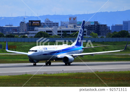 Osaka International Airport, a passenger plane taking off and landing Osaka International Airport, a passenger plane taking off and landing 92571311