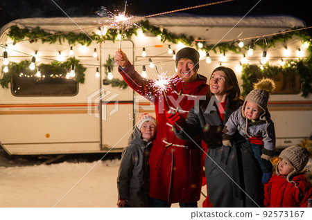Happy parents with three sons celebrating christmas in motorhome.  92573167