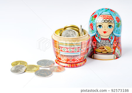 Traditional Russian toy matryoshka and money. White background. Copy space Traditional Russian toy matryoshka and money. White background. Copy space 92573186