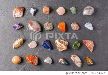 Mineral stones on a black concrete background. The concept of using minerals in astrology and alternative or complementary medicine. 92573324