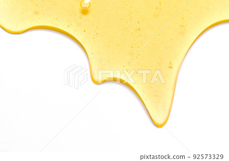 Fresh honey or synthetic oil or vegetable oil. White background. Copy space. 92573329