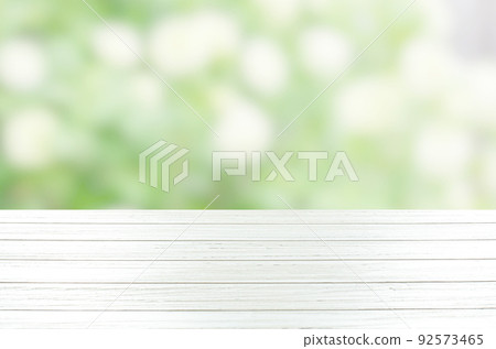 An empty white wooden table. Blurry summer or spring background. 92573465