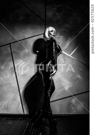 Sexy woman in a blonde wig and latex catsuit. Role-playing games Sexy woman in a blonde wig and latex catsuit. Role-playing games 92573829