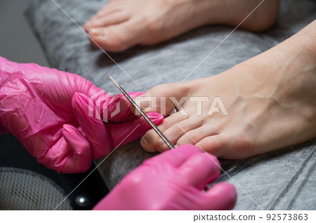 The master makes hardware pedicures to the client.  92573863