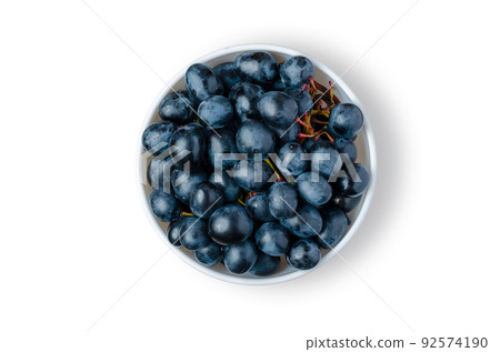 Black Grapes. Ripe berries in a white plate. Isolated on white. Black Grapes. Ripe berries in a white plate. Isolated on white. 92574190