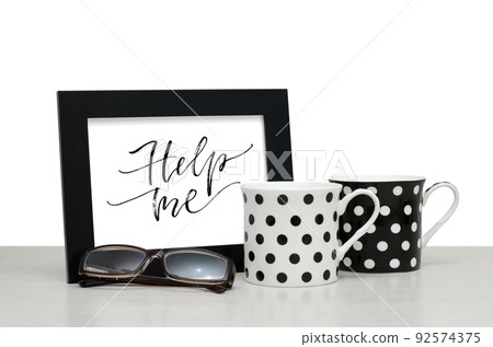 Help me. Handwritten inscription in the frame. Modern calligraphy. Coffee Cup, glasses Help me. Handwritten inscription in the frame. Modern calligraphy. Coffee Cup, glasses 92574375