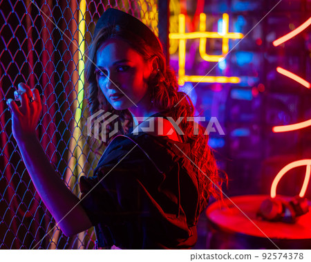 Caucasian woman posing in neon studio. Caucasian woman posing in neon studio. 92574378