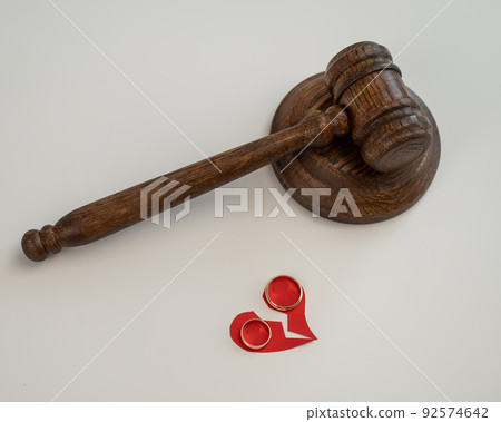Judicial gavel broken heart and wedding rings. Judicial gavel broken heart and wedding rings. 92574642
