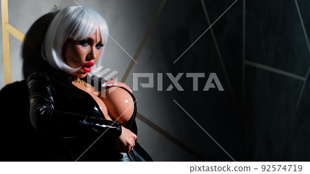 Sexy woman in a blonde wig and latex catsuit. Role-playing games 92574719