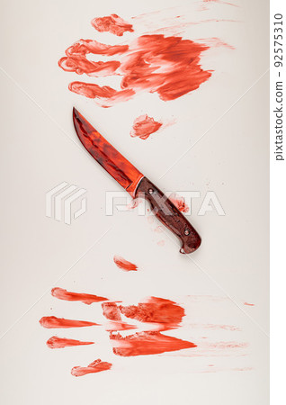 Bloody knife and hand prints in blood on a white table. Bloody knife and hand prints in blood on a white table. 92575310