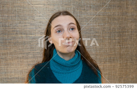 girl smiles skeptically 92575399