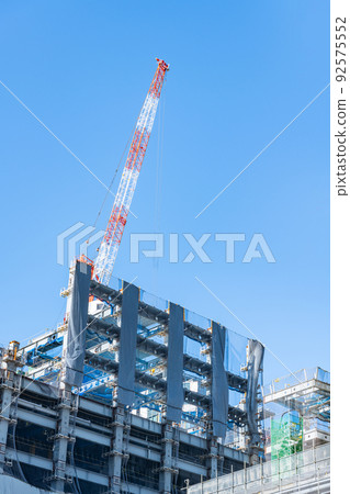 High-rise building construction site and large crane 92575552