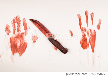 Bloody knife and hand prints in blood on a white table. Bloody knife and hand prints in blood on a white table. 92575827