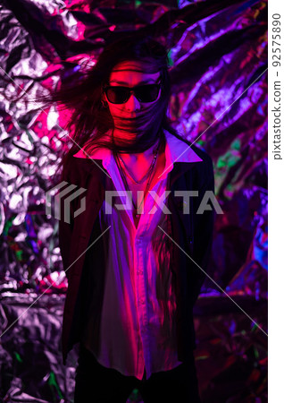 Portrait of a transgender model in sunglasses in a studio with neon lighting. Portrait of a transgender model in sunglasses in a studio with neon lighting. 92575890