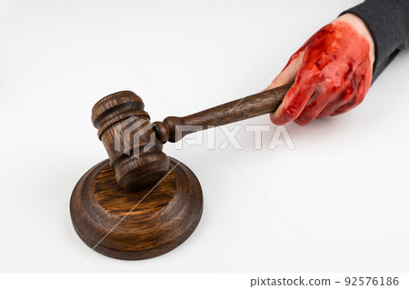 Female judge with bloody hands beats the gavel on a white background. 92576186
