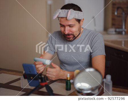 Men's beauty concept. caucAsian guy checking his skin. 92577296